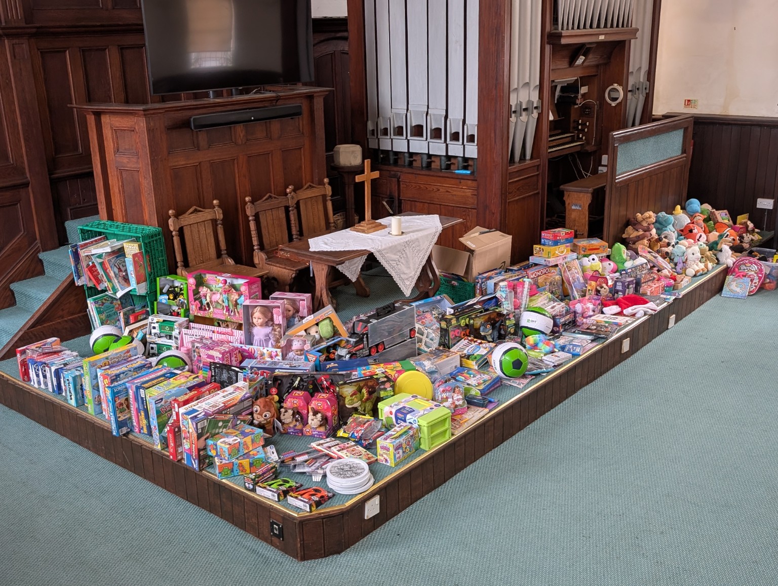 Secret Santa gifts arranged on the stage at Leiston United Church