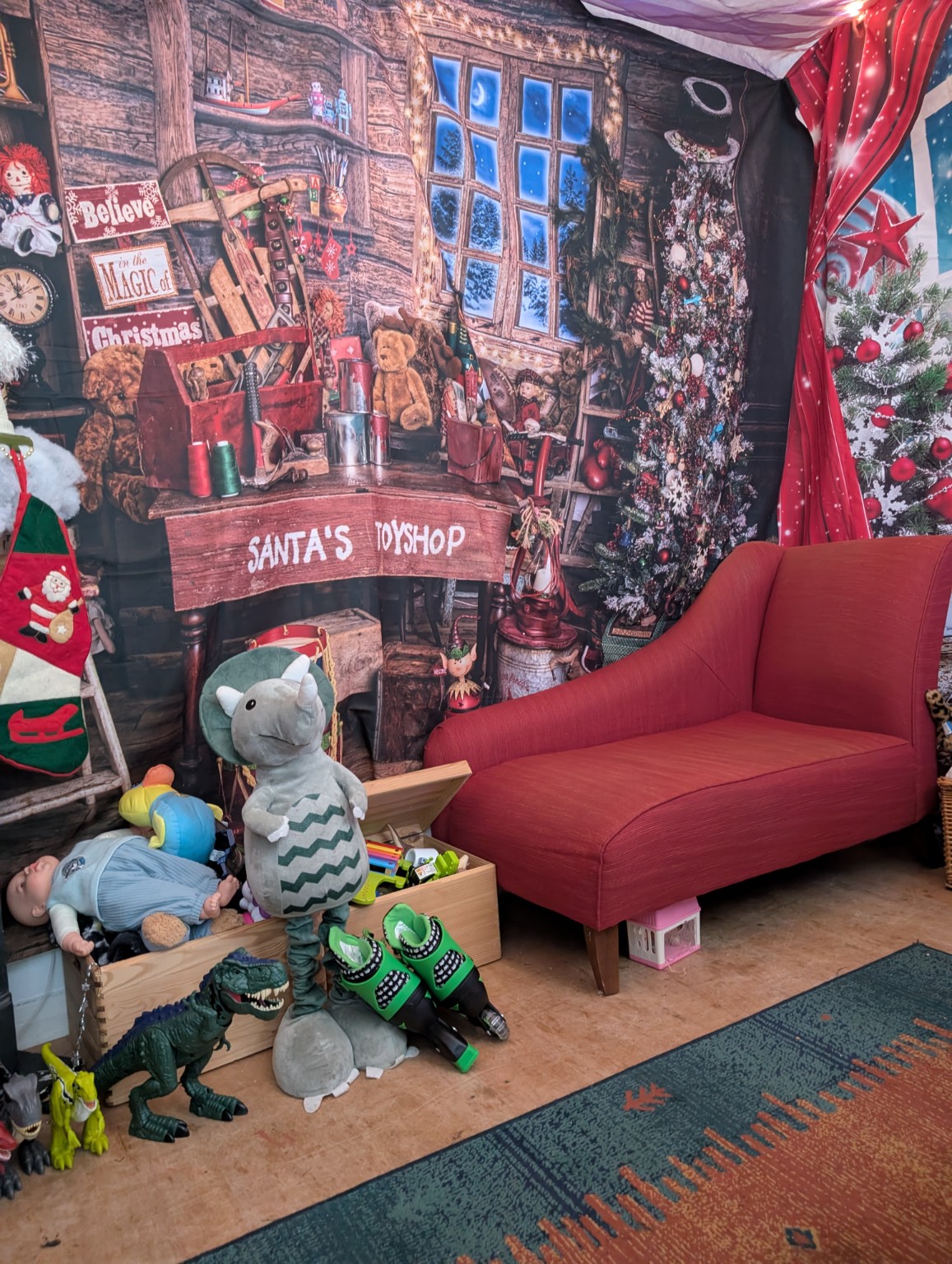 Santa’s Grotto at Project40Seven, with a red chair and festive toyshop backdrop