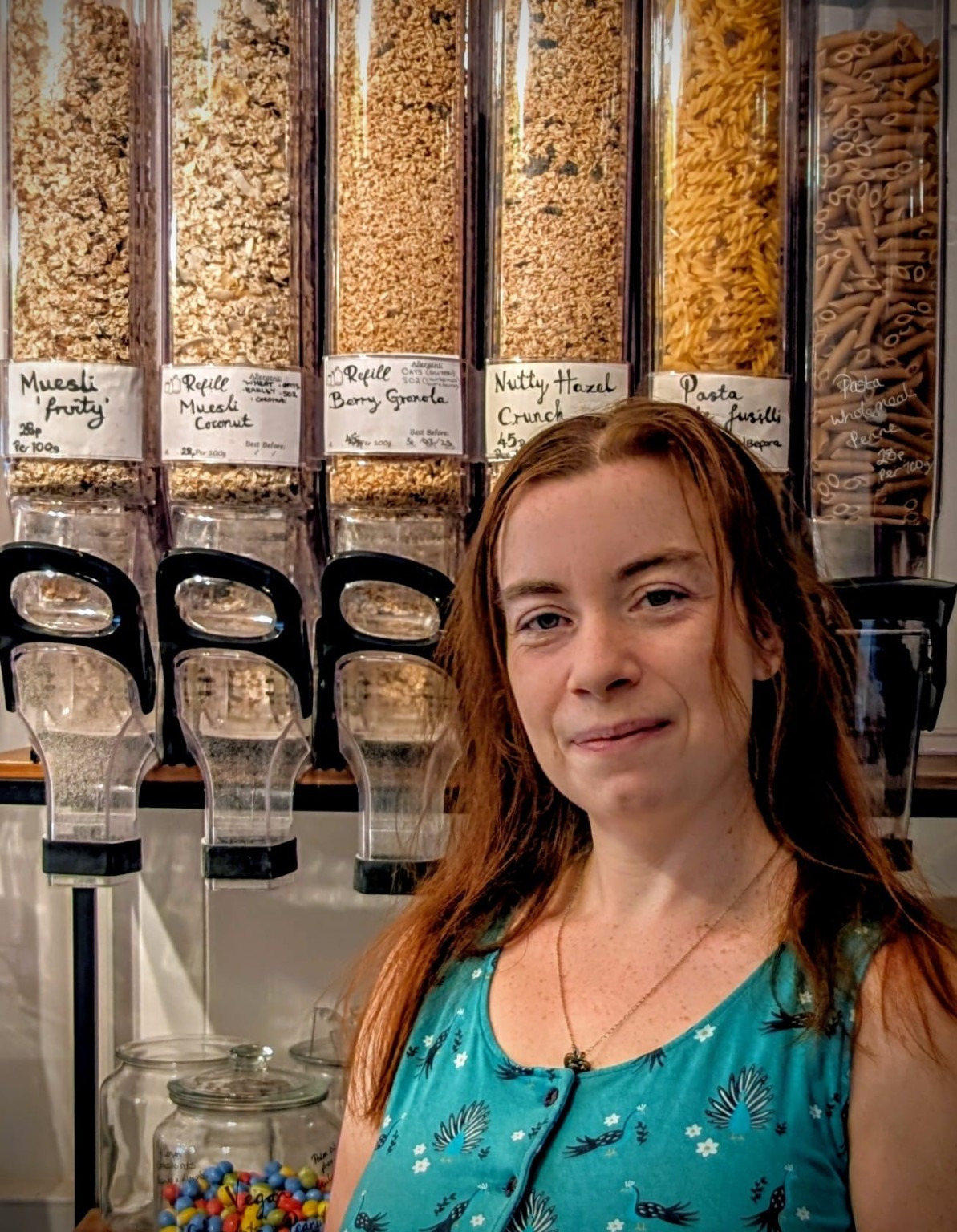 Amanda at Refill Leiston beside the food refill dispensers