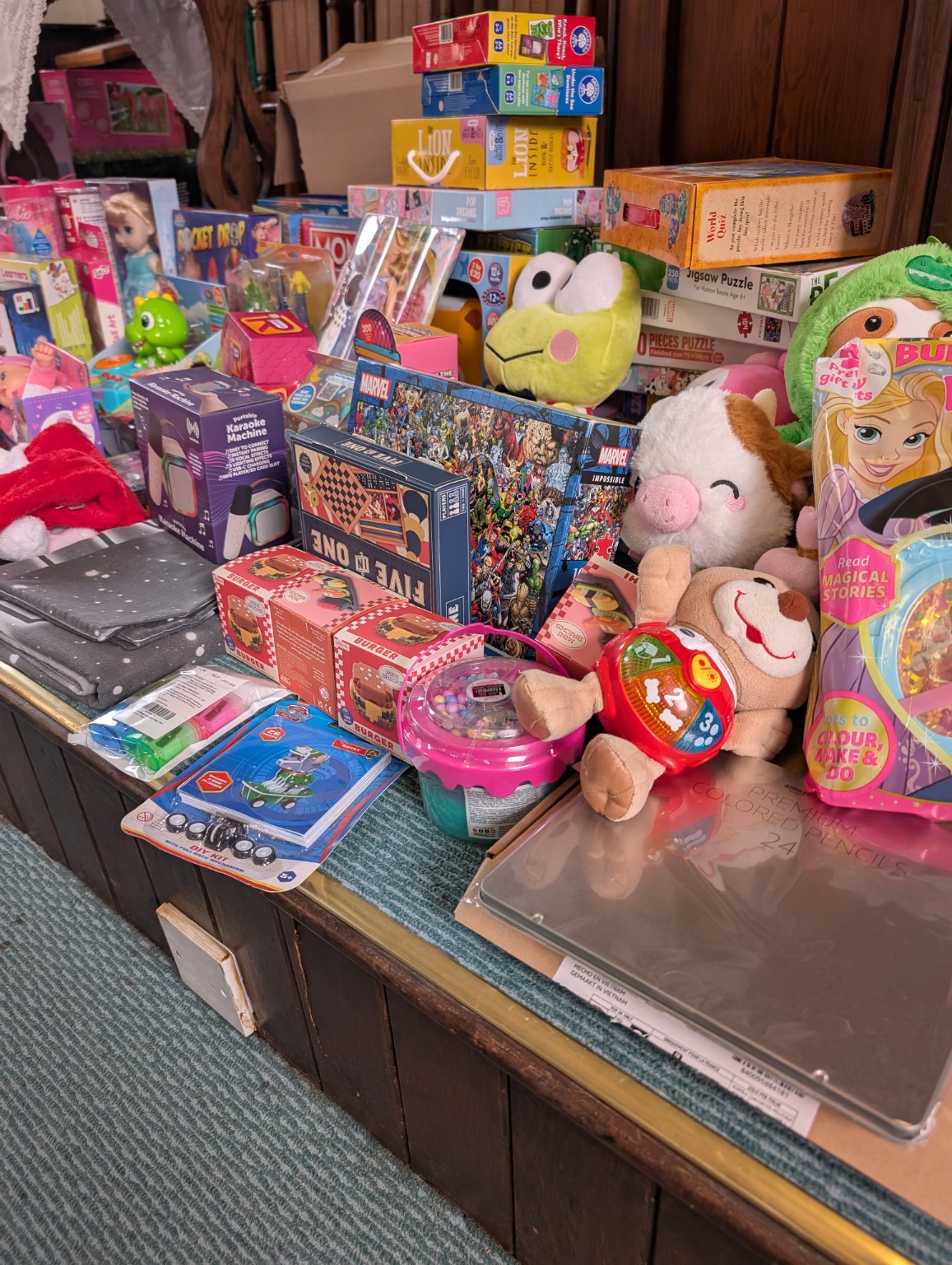 A close view of Secret Santa gifts, including games, books and soft toys
